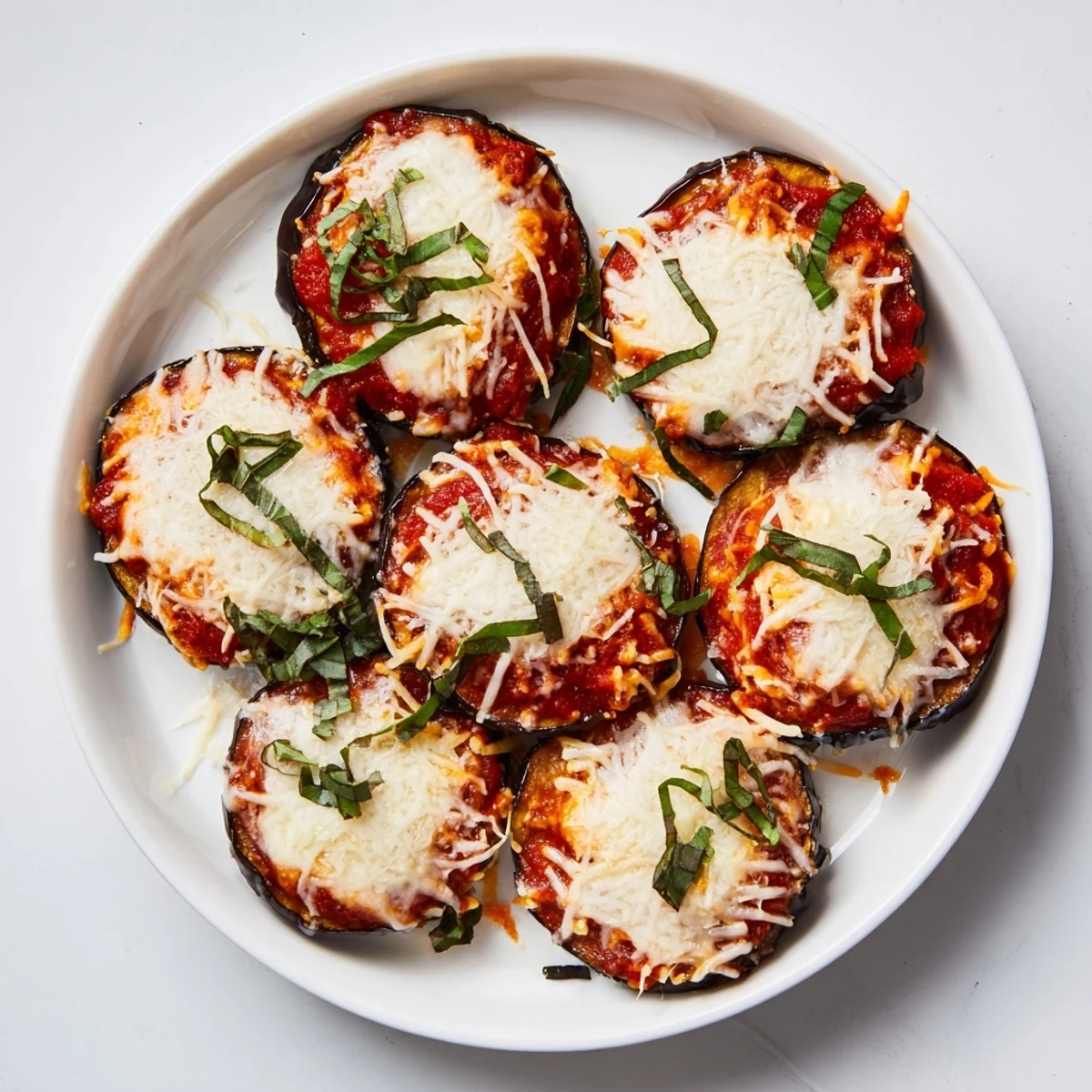 Golden-baked eggplant parmesan with molten cheese and rich marinara; a comforting Italian meal.