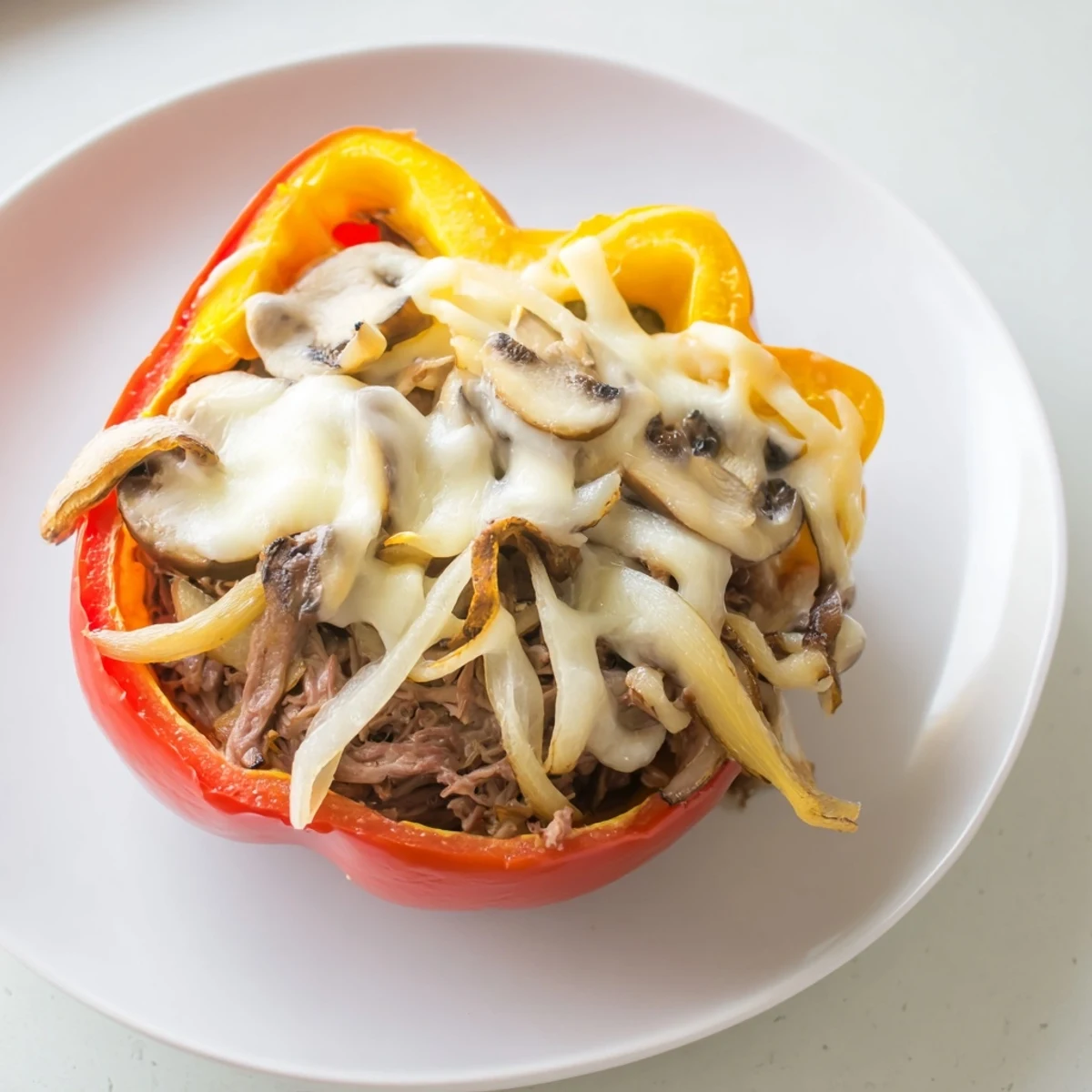 Imagine tender beef and onions nestled inside baked bell peppers – a flavorful Beef Philly Cheesesteak Stuffed Peppers creation.
