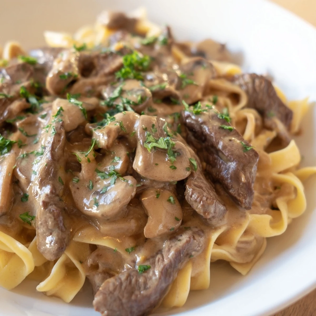 Tender beef strips and sautéed mushrooms smothered in a creamy gravy, served over egg noodles.
