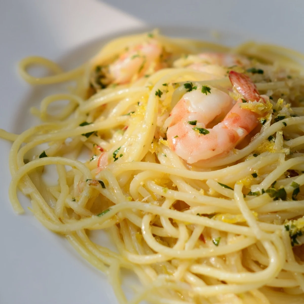 Bright and zesty Lemon Shrimp Pasta with garlic, featuring tender shrimp and al dente spaghetti tossed in a buttery lemon sauce.