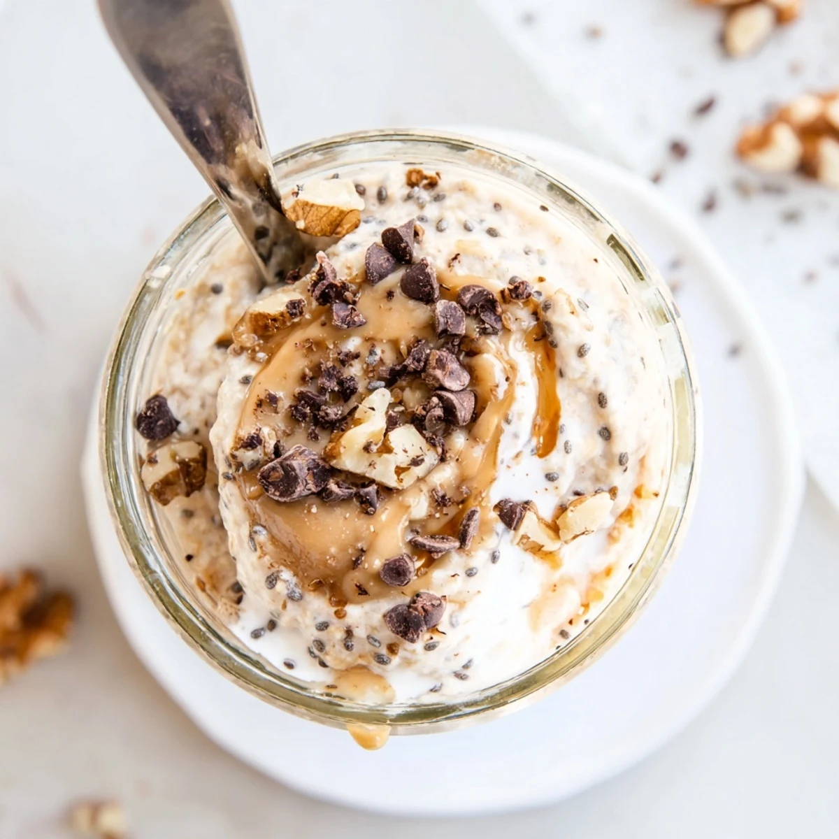 This creamy Cookie Dough Overnight Oats breakfast is layered with oats and yogurt in a glass jar.