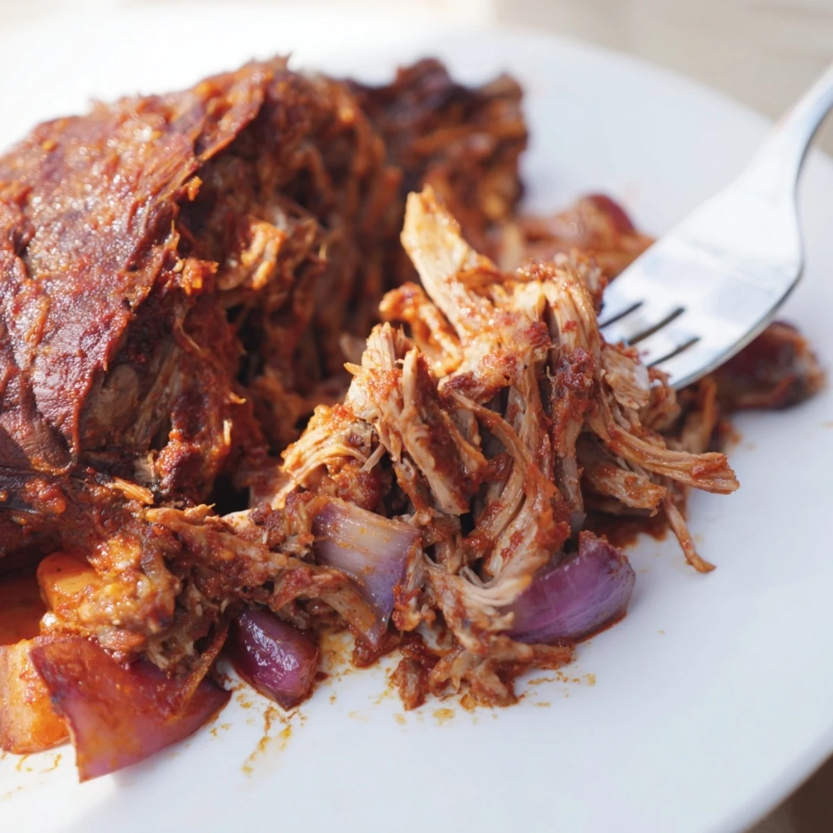 Family-style platter featuring the Slow Roasted Harissa Lamb Shoulder, garnished with fresh herbs and accompanied by warm flatbreads for dipping.