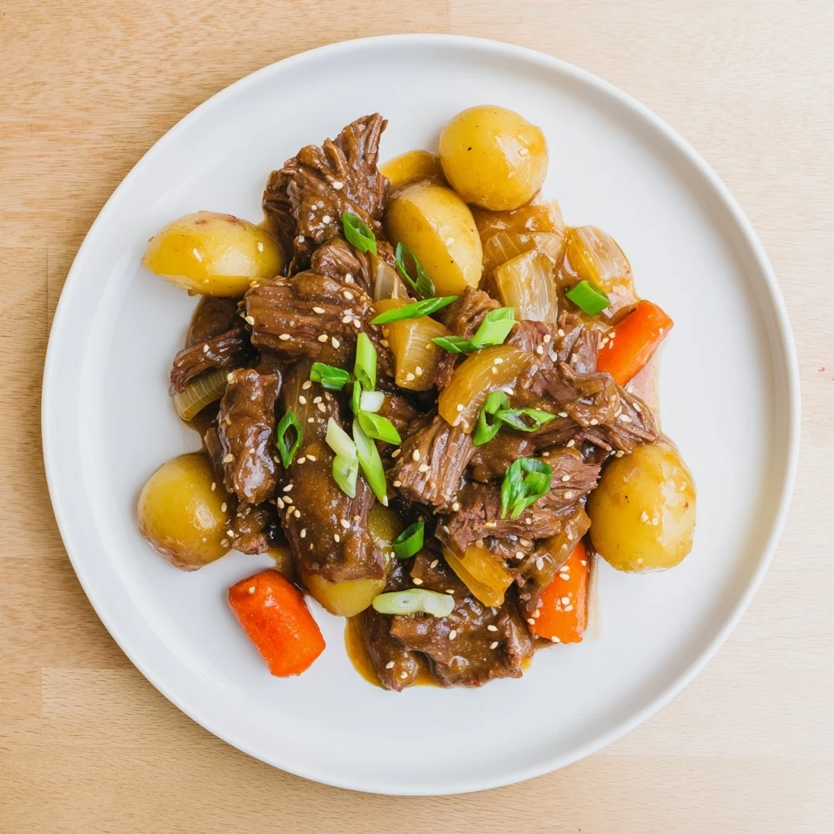 Aromatic soy garlic gravy drizzled over Slow Cooker Korean Beef Pot Roast beside fluffy rice and kimchi.