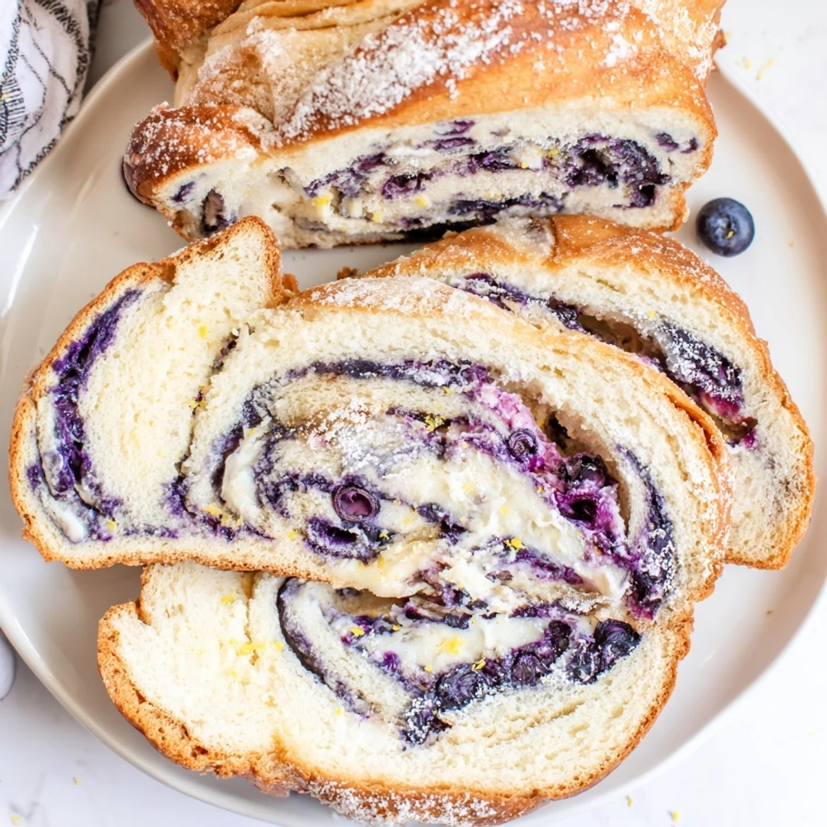 A slice of warm Blueberry Lemon Cream Cheese Sourdough with creamy swirls, served on a wooden board.