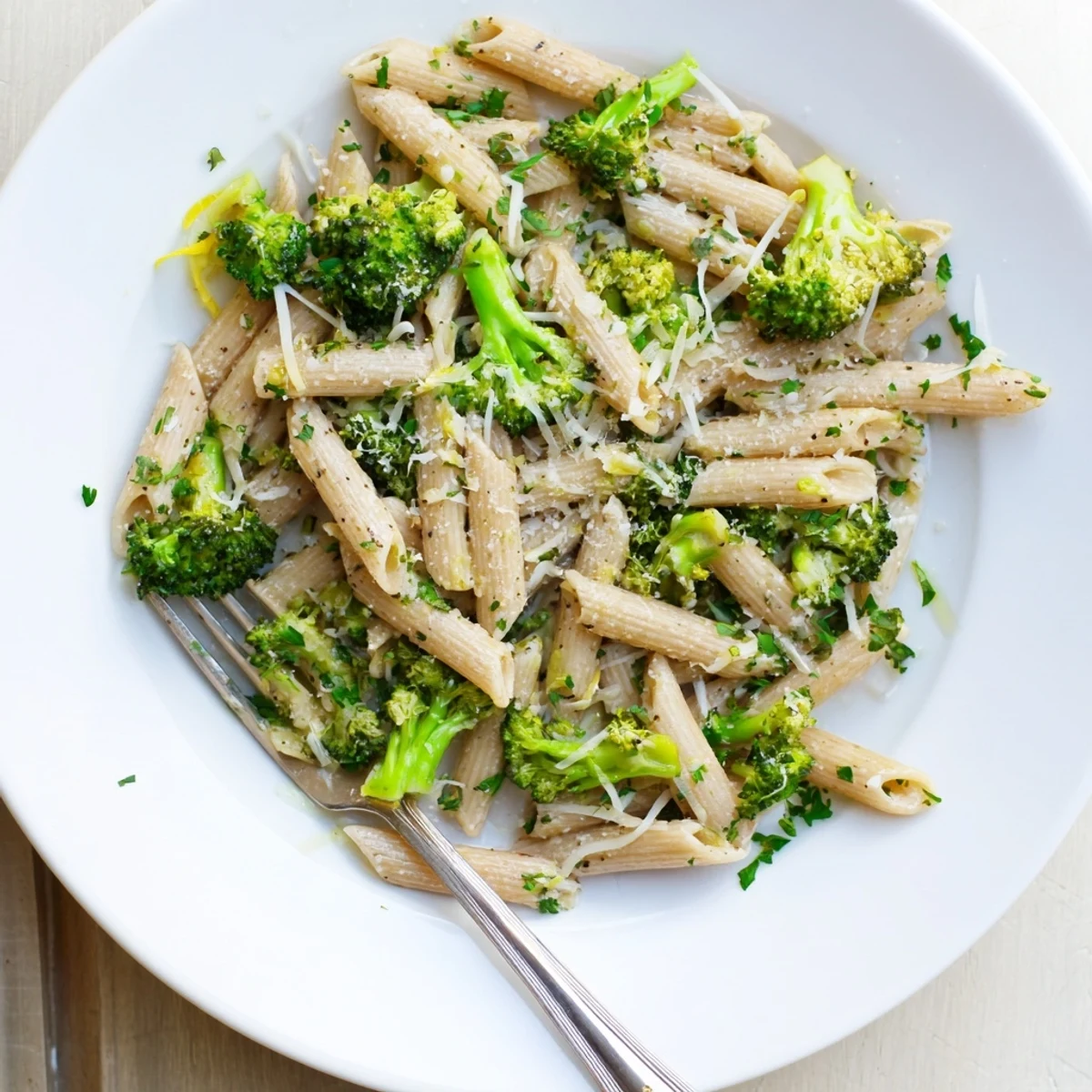 Freshly cooked Easy Healthy Broccoli Pasta steaming in a skillet with bright green florets and melted Parmesan.