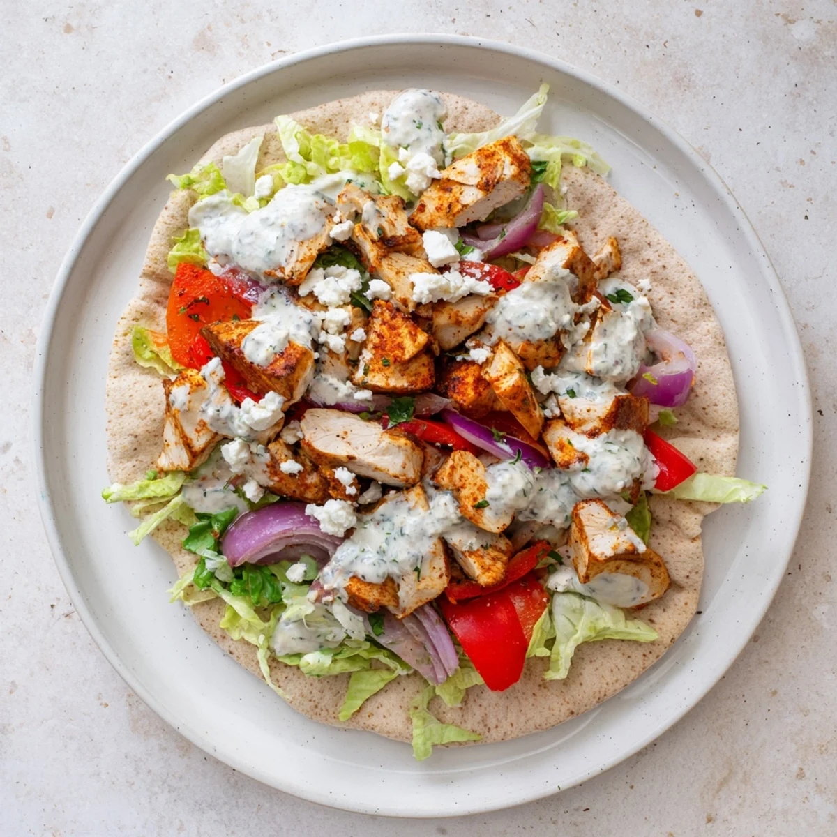 Family-friendly chicken pitas topped with fresh lettuce and tangy homemade ranch dressing