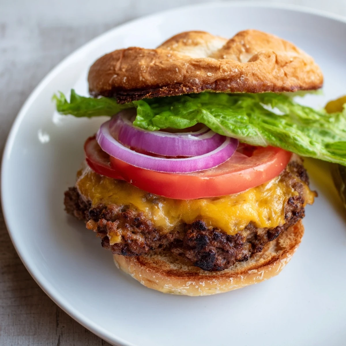 Crispy-edged beef smash burger stacked with fresh lettuce tomato and red onion