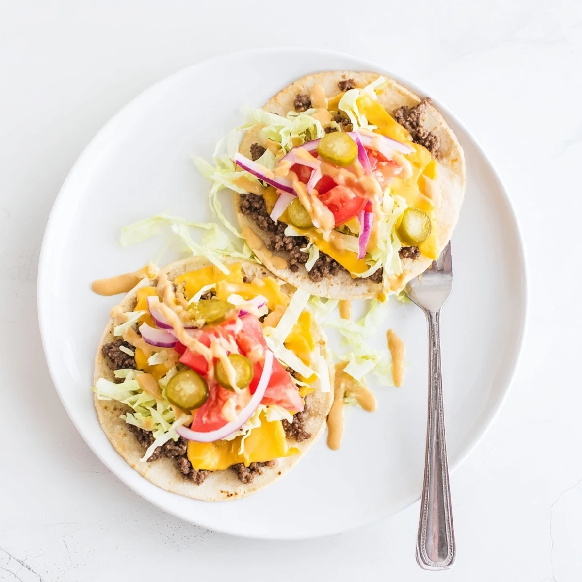 Golden crispy smash burger tacos loaded with melted cheese and fresh vegetable toppings