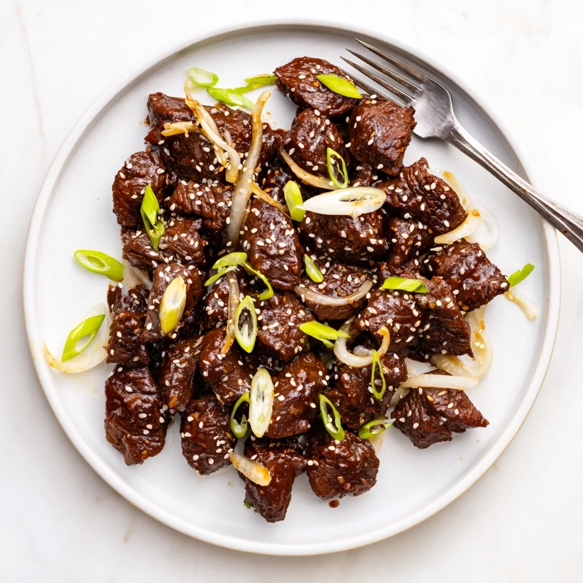 Savory slow cooker Korean beef served over steamed white rice with fresh green onion sprinkles