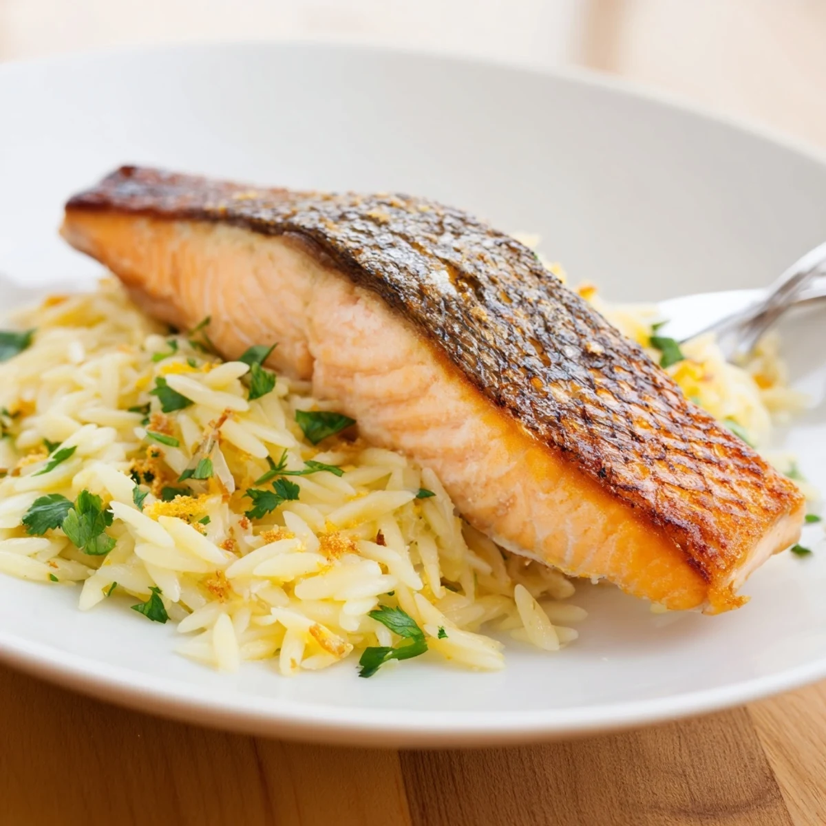 One skillet salmon with lemon orzo featuring flaky fish and bright citrus flavor