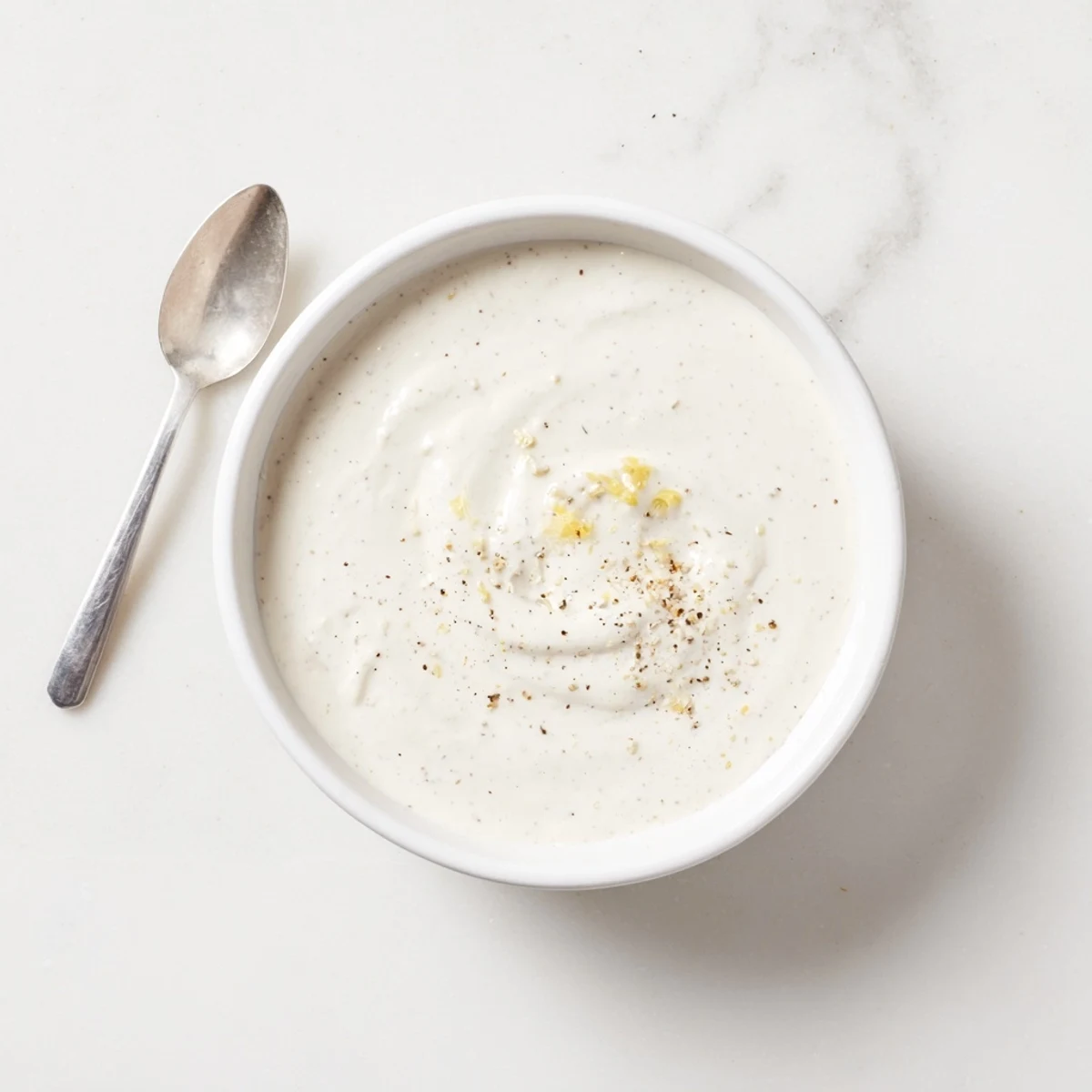 Creamy white chicken shawarma garlic sauce drizzled generously over sliced spiced meat in a warm pita bowl