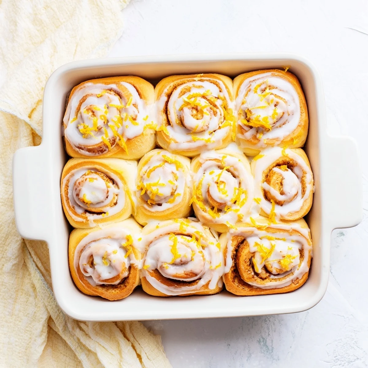 Golden lemon rolls fresh from the oven drizzled with tangy lemon glaze