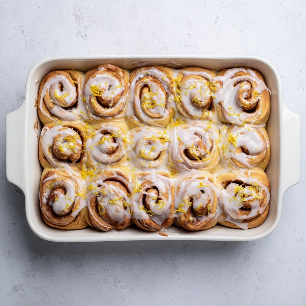 Soft lemon rolls with sweet citrus filling baked in a round pan