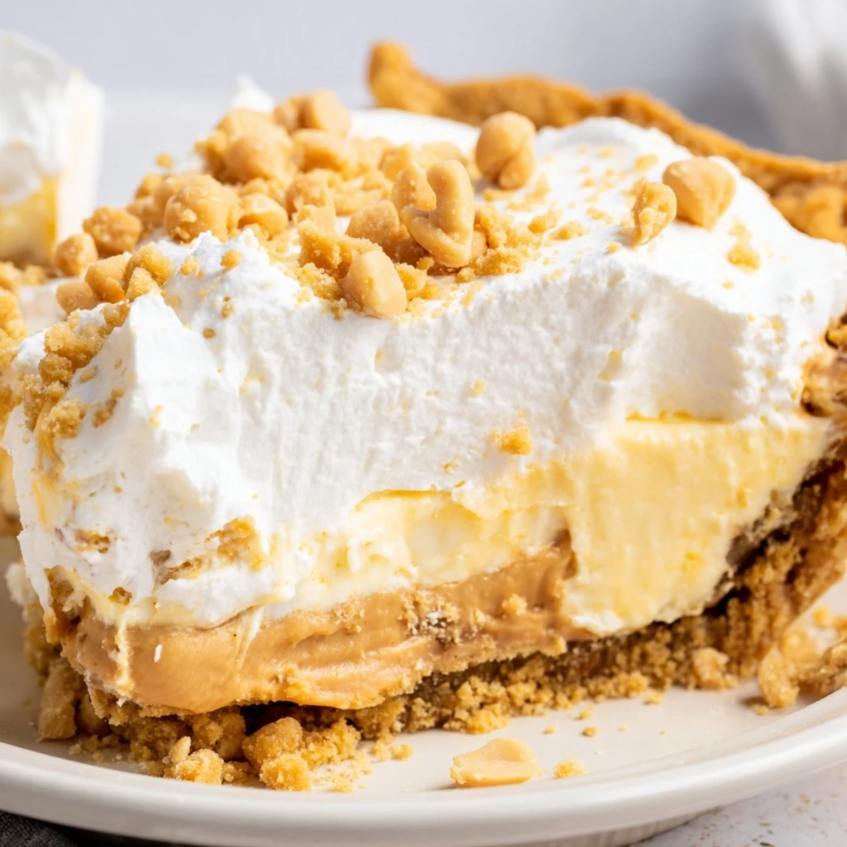 Creamy Amish Peanut Butter Dream Pie with fluffy whipped topping and golden crumbs