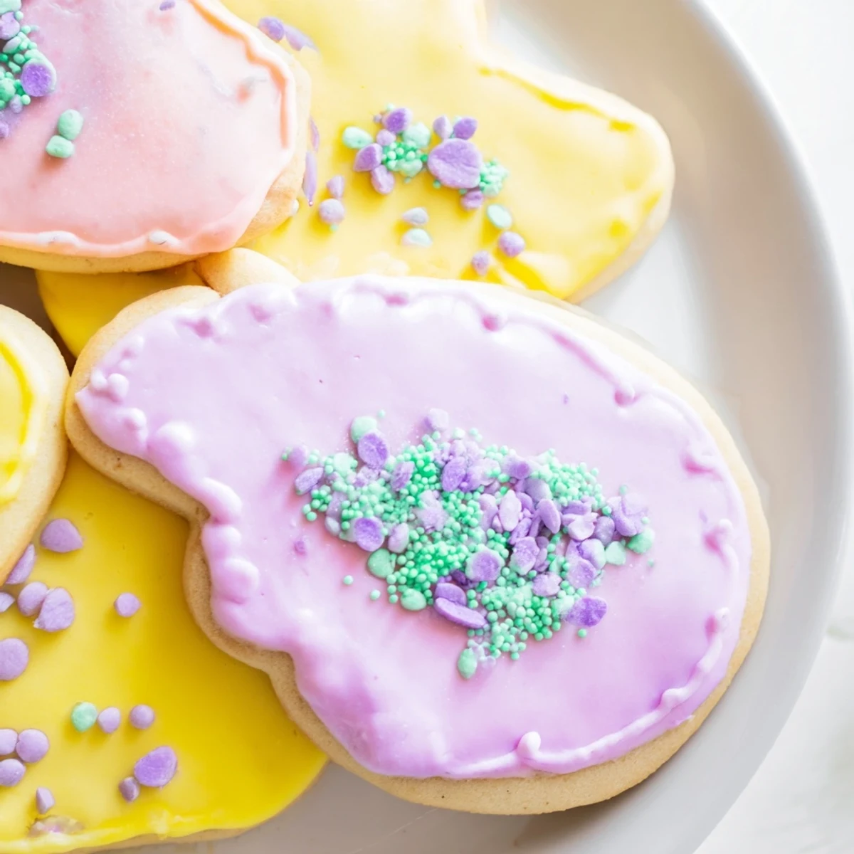 Colorful Spring Easter cookies decorated with smooth royal icing and rainbow sprinkles