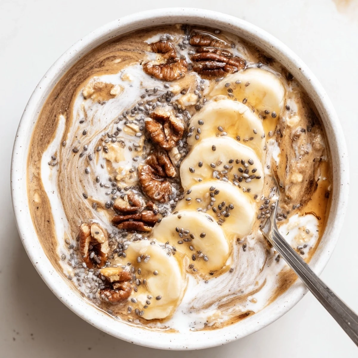 Chilled Brown Sugar Coffee Overnight Oats in mason jar, topped with toasted pecans