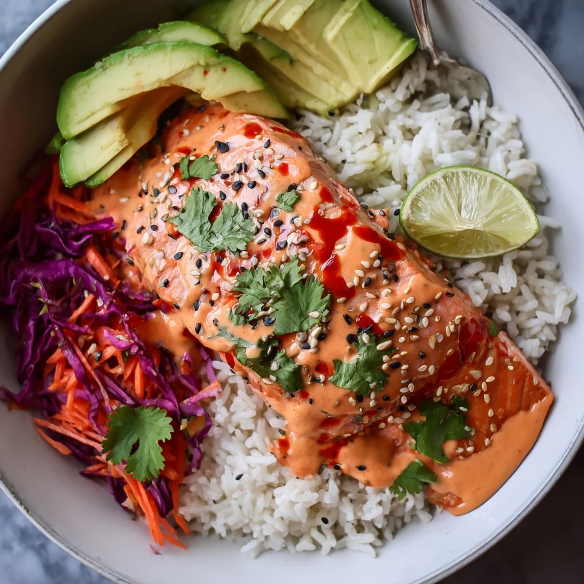 Bang Bang Salmon Bowls with roasted flaky salmon, avocado, rice, creamy sauce