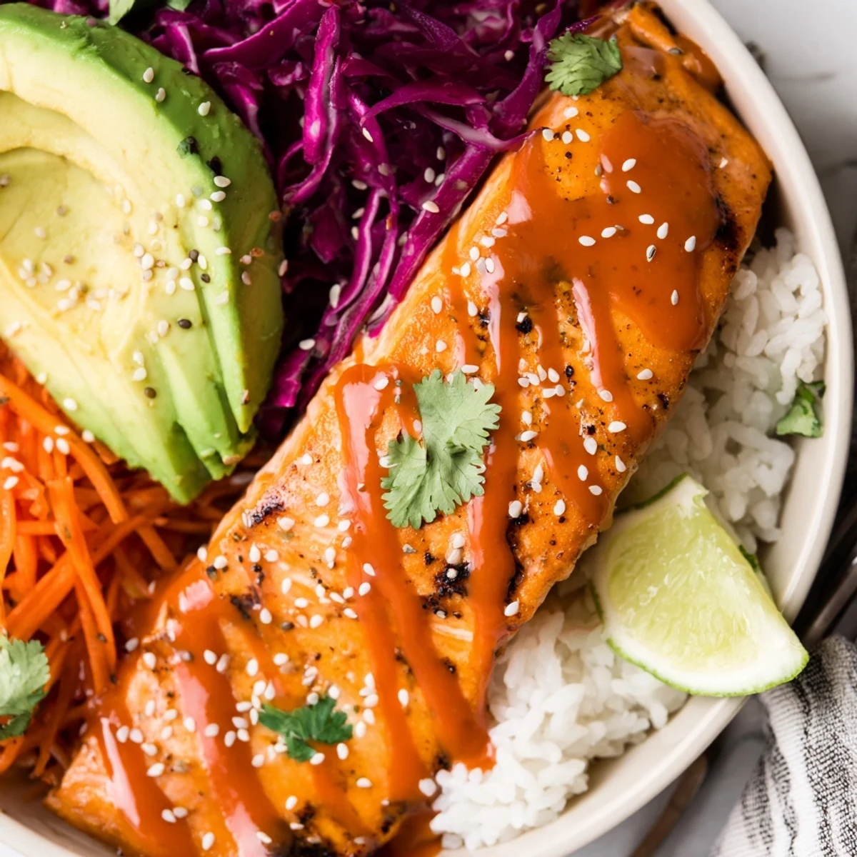 Weeknight Bang Bang Salmon Bowls served over warm jasmine rice, crisp cabbage