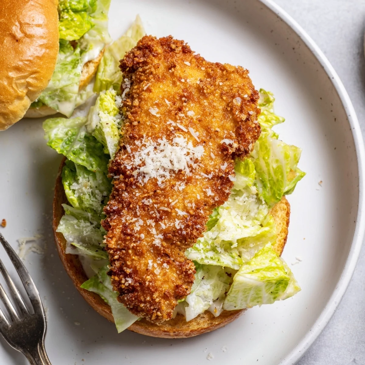 Crispy Chicken Caesar Sandwich Recipe plated with lemon wedge, crunchy panko crust visible