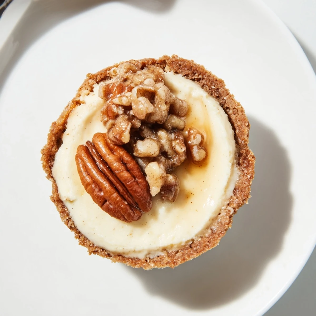 Cooling tray of Mini Pecan Pie Cheesecakes after baking, steam faintly.
