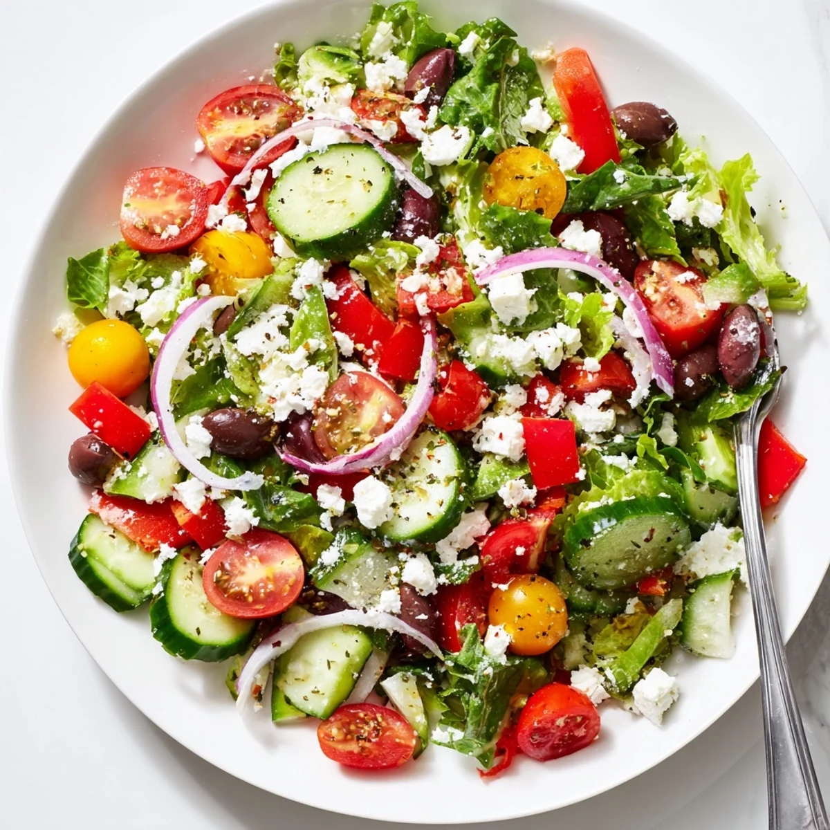 Bright Fresh Salad Recipe tossed with feta, olives, and zesty vinaigrette