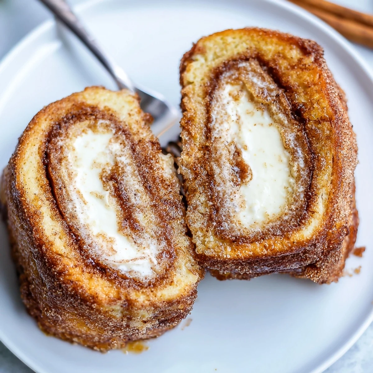 Cinnamon Roll French Toast Roll Ups warm and golden with cinnamon sugar glaze  