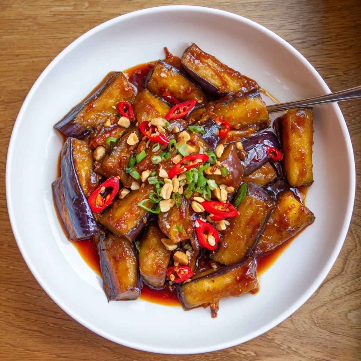 Golden pan fried batons in Sichuan Style Braised Aubergines, garlic and sesame finish