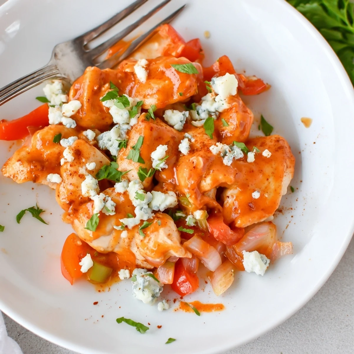 Keto Buffalo Chicken Skillet sizzling, creamy sauce coating chicken and melting cheese