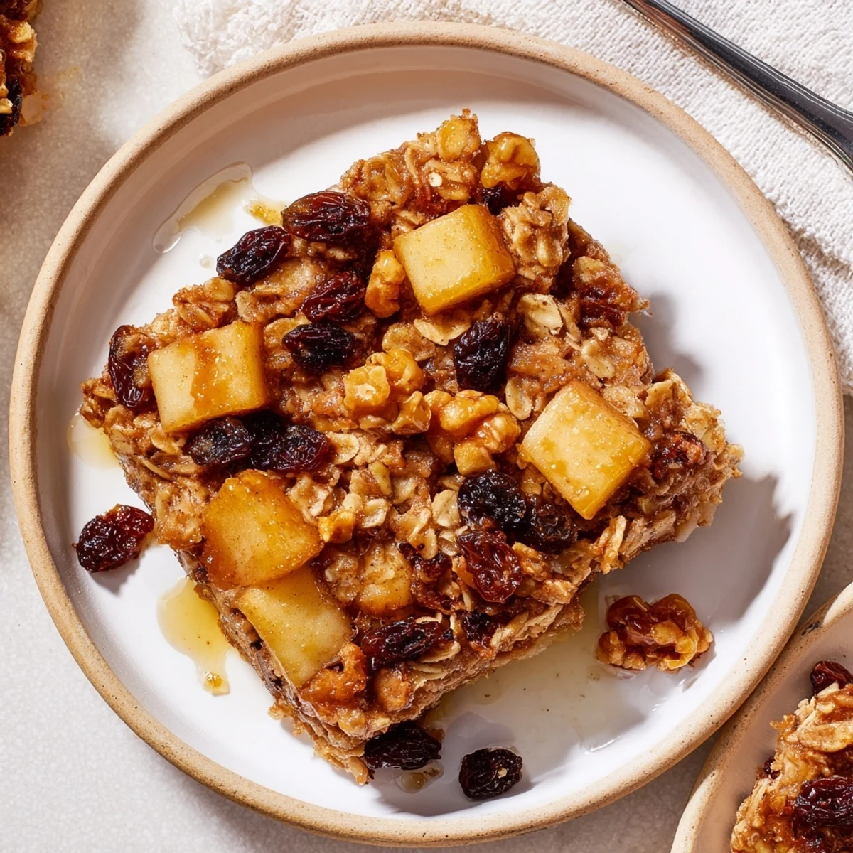 Delicious Apple Cinnamon Oatmeal Bake Recipe For Mornings golden and steaming, served with yogurt