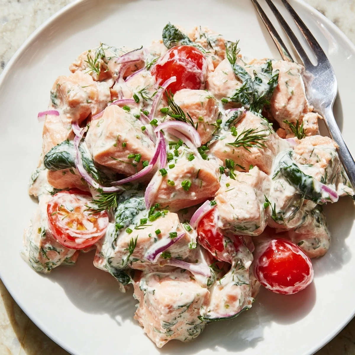 Creamy leftover salmon recipe loaded with spinach, tomatoes, and fresh dill