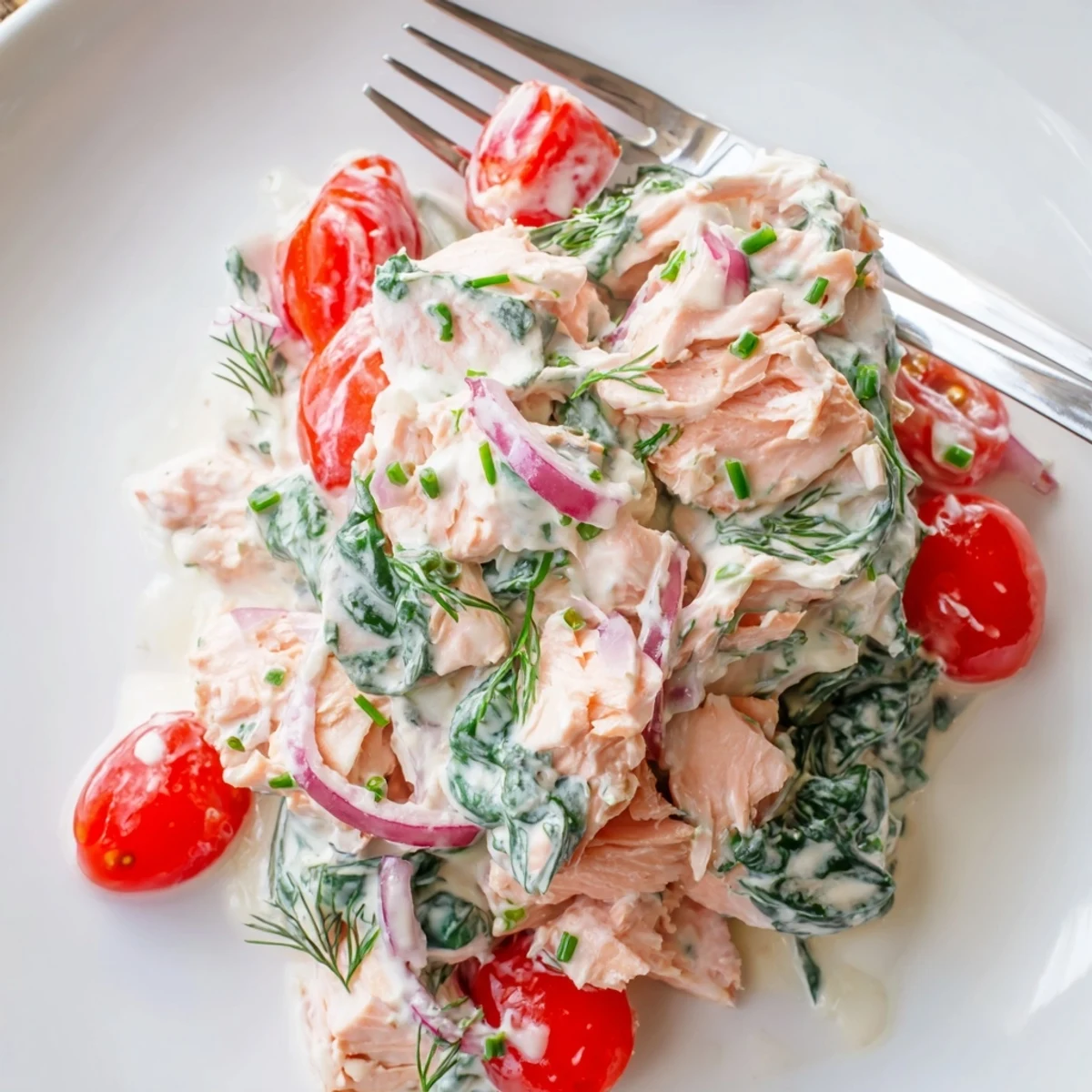 Golden pink leftover salmon recipe topped with chives and lemon zest